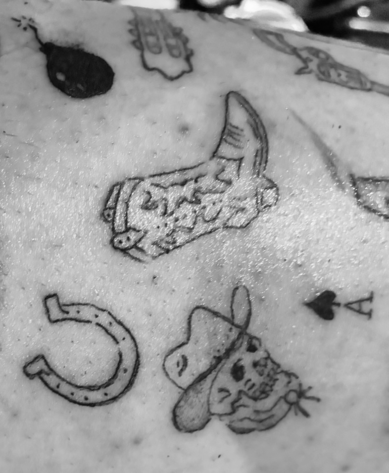 Fine line flash tattoos including a sock, horseshoe, bomb and skull
